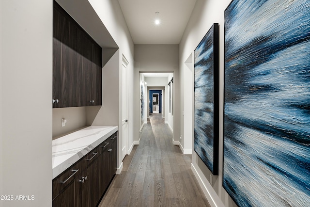 hall with wood finished floors and baseboards