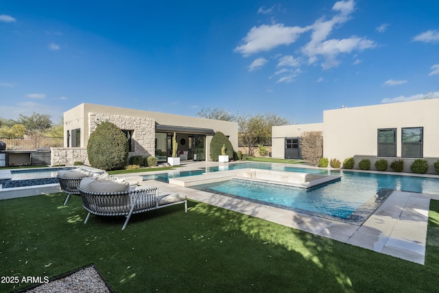 outdoor pool with a patio area, a lawn, and a hot tub