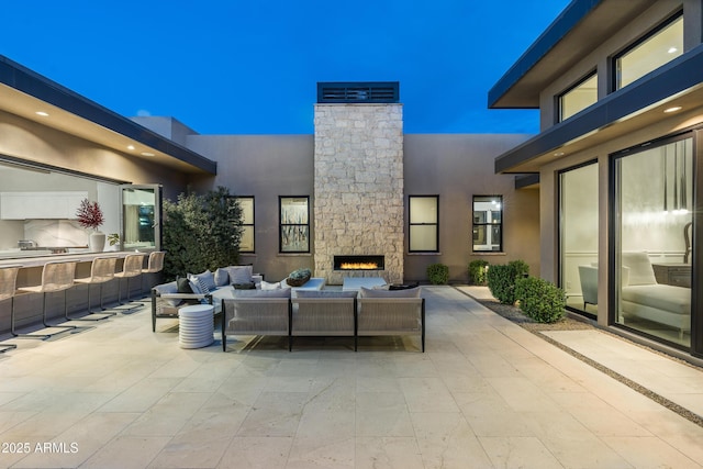 view of patio / terrace featuring an outdoor kitchen and an outdoor living space with a fireplace