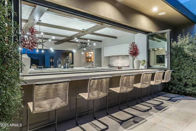 bar featuring beam ceiling, coffered ceiling, tasteful backsplash, recessed lighting, and wet bar