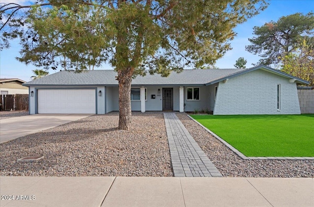 ranch-style house with a front lawn and a garage