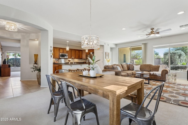 dining space featuring a wealth of natural light, visible vents, recessed lighting, and light carpet