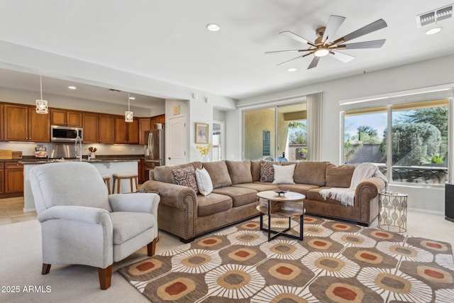 living room featuring recessed lighting, visible vents, light carpet, and ceiling fan