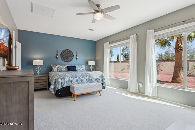 bedroom with a ceiling fan, visible vents, and carpet floors