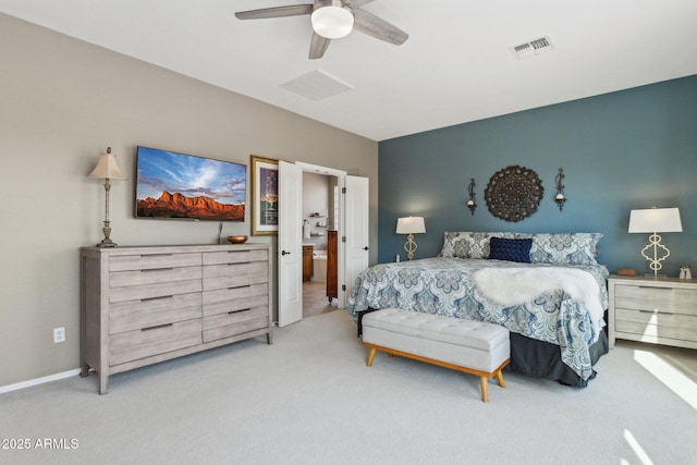 carpeted bedroom featuring baseboards, visible vents, ensuite bath, and a ceiling fan