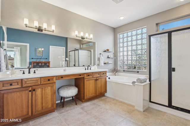 full bath featuring a sink, a shower stall, a garden tub, and double vanity