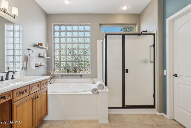 bathroom featuring a garden tub, a shower stall, vanity, and tile patterned flooring