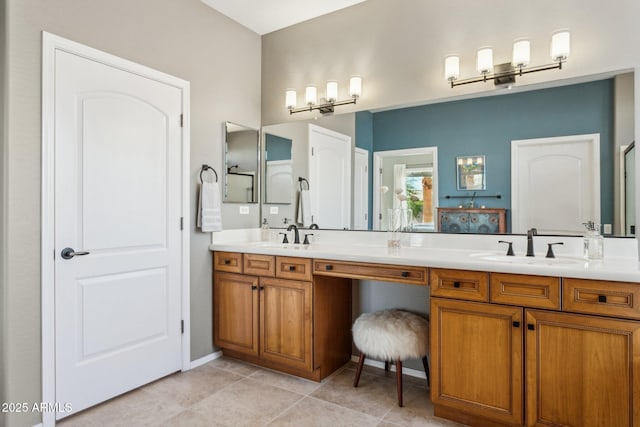 full bath featuring double vanity, tile patterned floors, and a sink