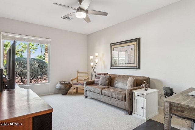 living room with ceiling fan, baseboards, visible vents, and light carpet