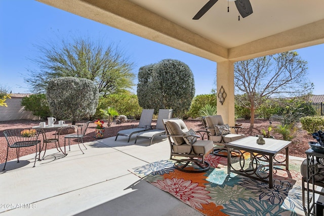 view of patio featuring a ceiling fan and fence