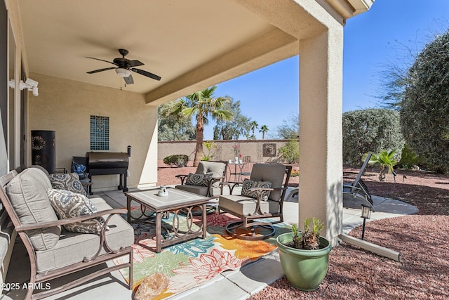 view of patio / terrace featuring an outdoor hangout area, a ceiling fan, and fence