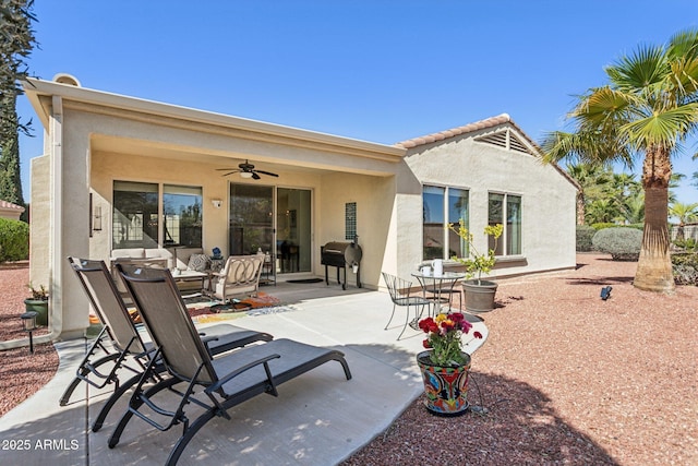 back of property with a patio, a ceiling fan, and stucco siding