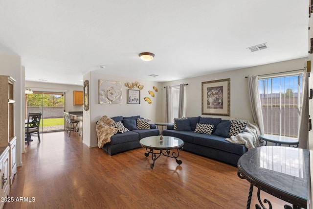 living room with wood finished floors and visible vents