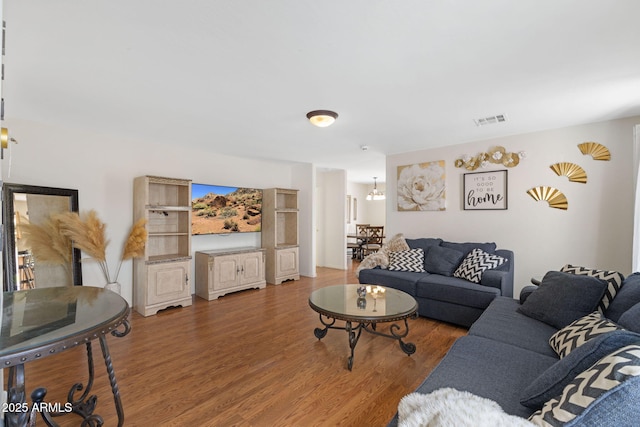 living room featuring visible vents and wood finished floors