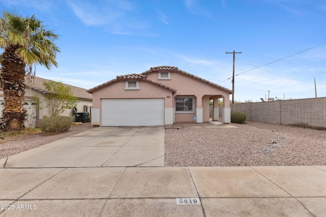 mediterranean / spanish-style home featuring fence, an attached garage, stucco siding, concrete driveway, and a tile roof