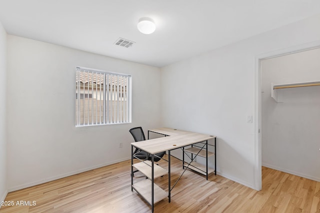 office space with visible vents, baseboards, and wood finished floors