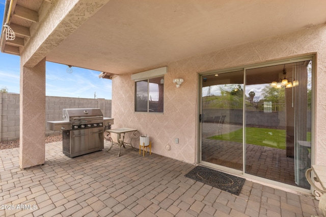view of patio featuring area for grilling and fence