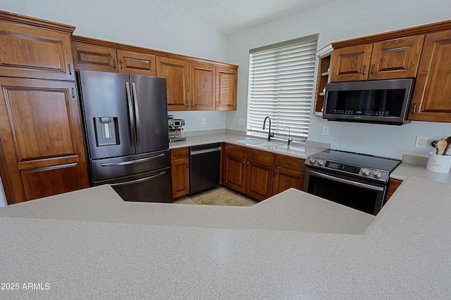 kitchen with sink, lofted ceiling, and stainless steel appliances