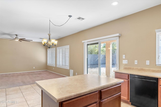 kitchen with light tile patterned floors, ceiling fan with notable chandelier, dishwasher, a kitchen island, and decorative light fixtures