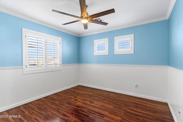 spare room featuring crown molding, ceiling fan, a healthy amount of sunlight, and dark hardwood / wood-style flooring