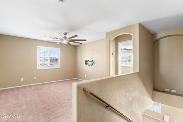 staircase featuring carpet flooring and ceiling fan