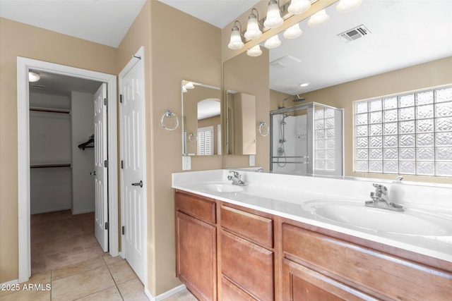 bathroom featuring vanity, tile patterned floors, and a shower with shower door