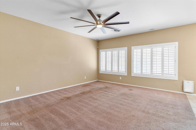 empty room featuring light colored carpet and ceiling fan