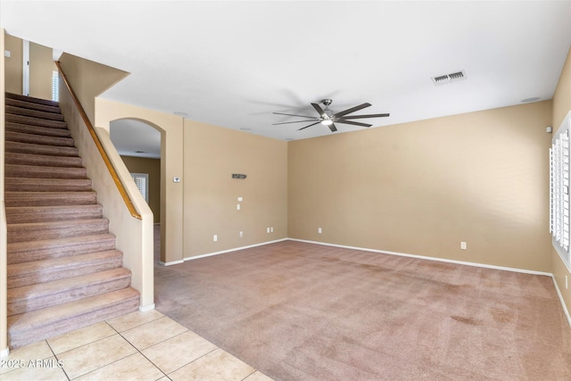 carpeted empty room featuring ceiling fan