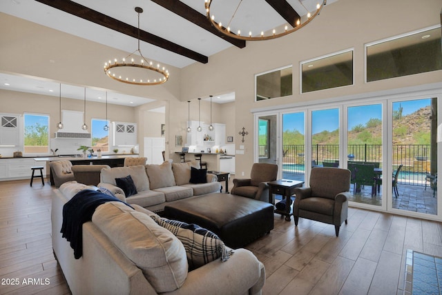 29067 N 71st Ave, Peoria, AZ 85383 - living area with a chandelier, wood finished floors, a towering ceiling, and beam ceiling