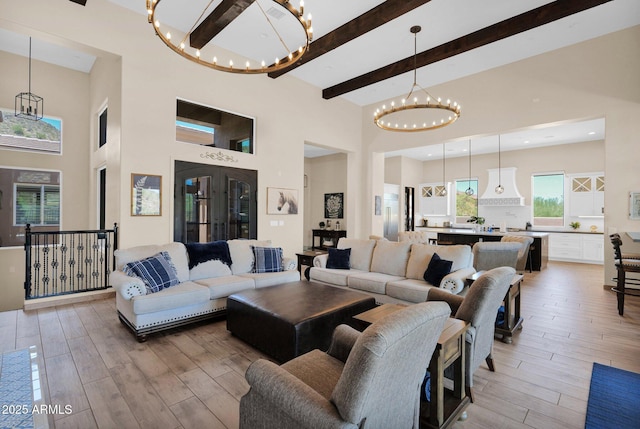 29067 N 71st Ave, Peoria, AZ 85383 - living area with a chandelier, beamed ceiling, a high ceiling, light wood-style flooring, and recessed lighting