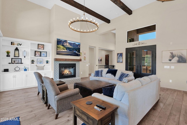 29067 N 71st Ave, Peoria, AZ 85383 - living area with a high ceiling, a chandelier, light wood-style floors, a tile fireplace, and beamed ceiling