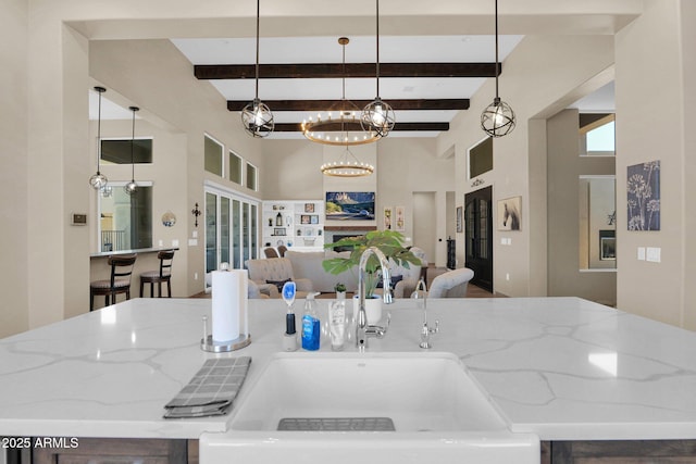 29067 N 71st Ave, Peoria, AZ 85383 - kitchen with open floor plan, light stone countertops, plenty of natural light, beamed ceiling, and a towering ceiling