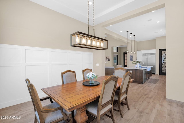 29067 N 71st Ave, Peoria, AZ 85383 - dining space featuring light wood-style floors, a decorative wall, and recessed lighting