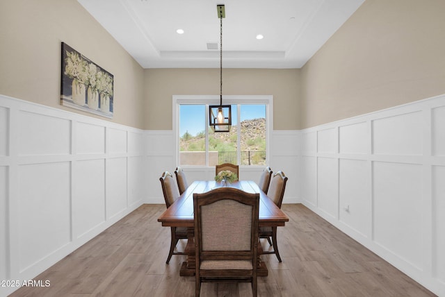29067 N 71st Ave, Peoria, AZ 85383 - dining room featuring a decorative wall, a raised ceiling, light wood-style floors, a wainscoted wall, and recessed lighting