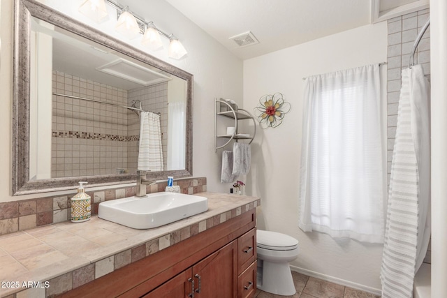 bathroom with toilet, vanity, tile patterned floors, and walk in shower