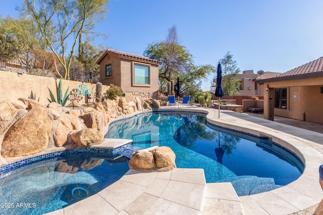 view of swimming pool with a patio area and a hot tub