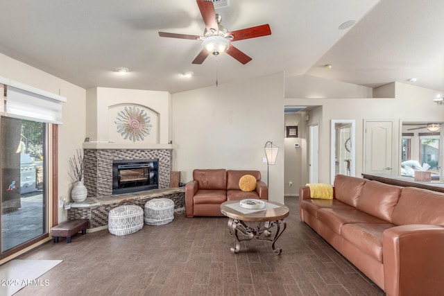 living room featuring ceiling fan, wood-type flooring, and a tiled fireplace