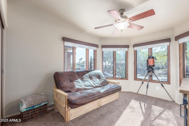 sunroom featuring ceiling fan and a wealth of natural light