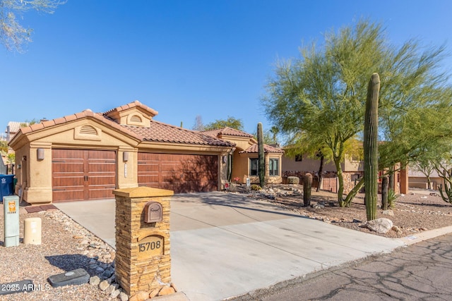 mediterranean / spanish-style home with a garage