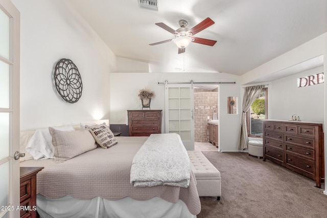 carpeted bedroom featuring vaulted ceiling, ceiling fan, connected bathroom, and a barn door