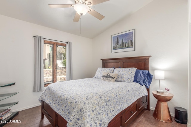 bedroom with ceiling fan, vaulted ceiling, and dark wood-type flooring