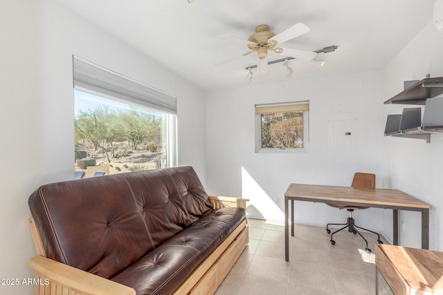 tiled home office with ceiling fan and electric panel