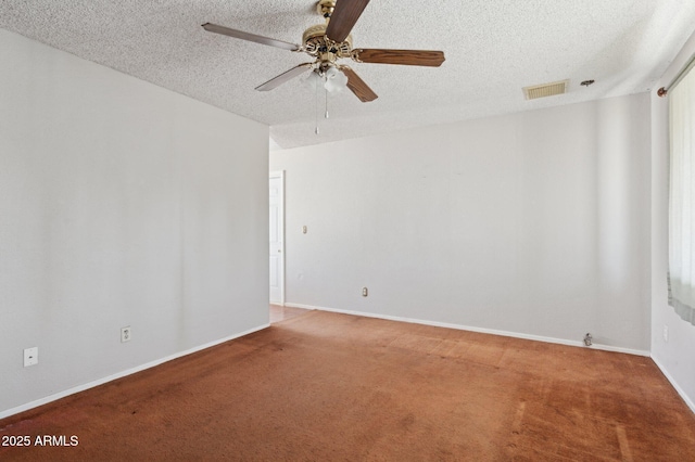 carpeted empty room featuring ceiling fan and a textured ceiling