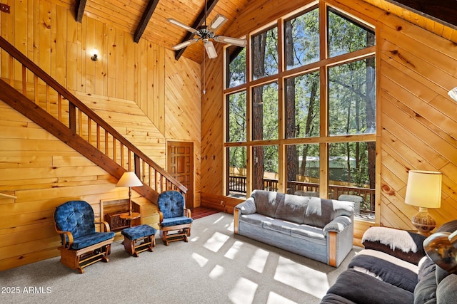 246 E Acorn Ln, Payson, AZ 85541 - carpeted living area featuring wood walls, a wooden ceiling with exposed beams, high vaulted ceiling, stairway, and ceiling fan