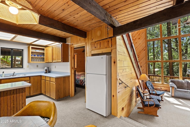246 E Acorn Ln, Payson, AZ 85541 - kitchen featuring freestanding refrigerator, light carpet, light countertops, a wood ceiling with exposed beams, and wood walls