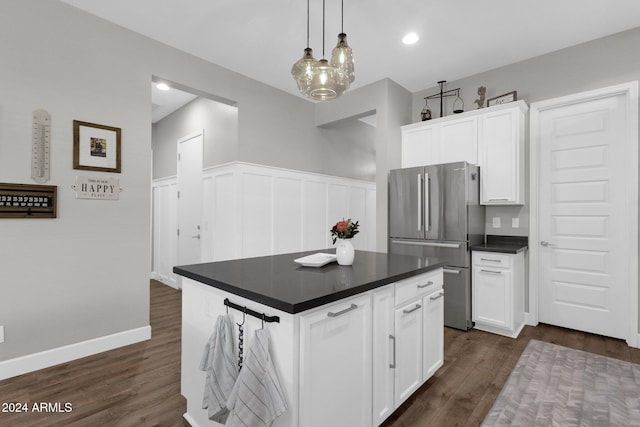 kitchen featuring stainless steel refrigerator, a kitchen island, dark hardwood / wood-style flooring, and white cabinetry