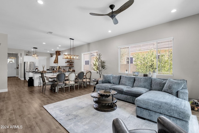 living room with hardwood / wood-style flooring and ceiling fan