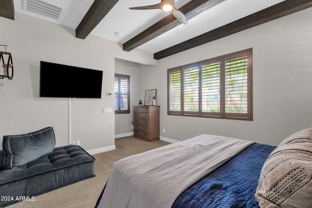 bedroom featuring beam ceiling, light carpet, and ceiling fan