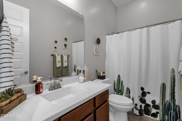 bathroom with curtained shower, vanity, toilet, and tile patterned floors