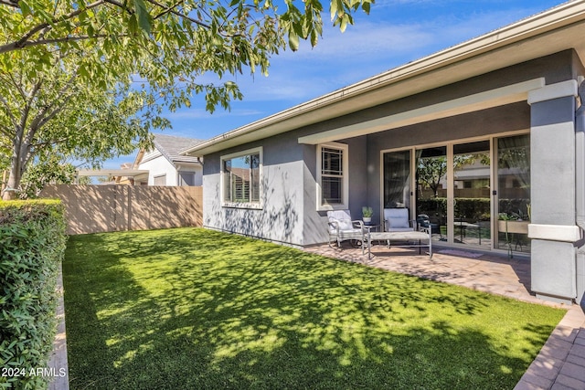 back of house featuring a yard and a patio